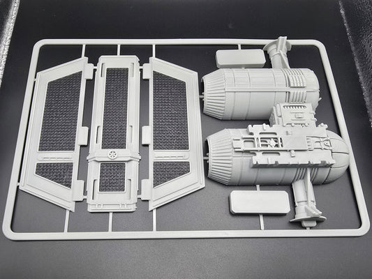 Model kit components on a gray background