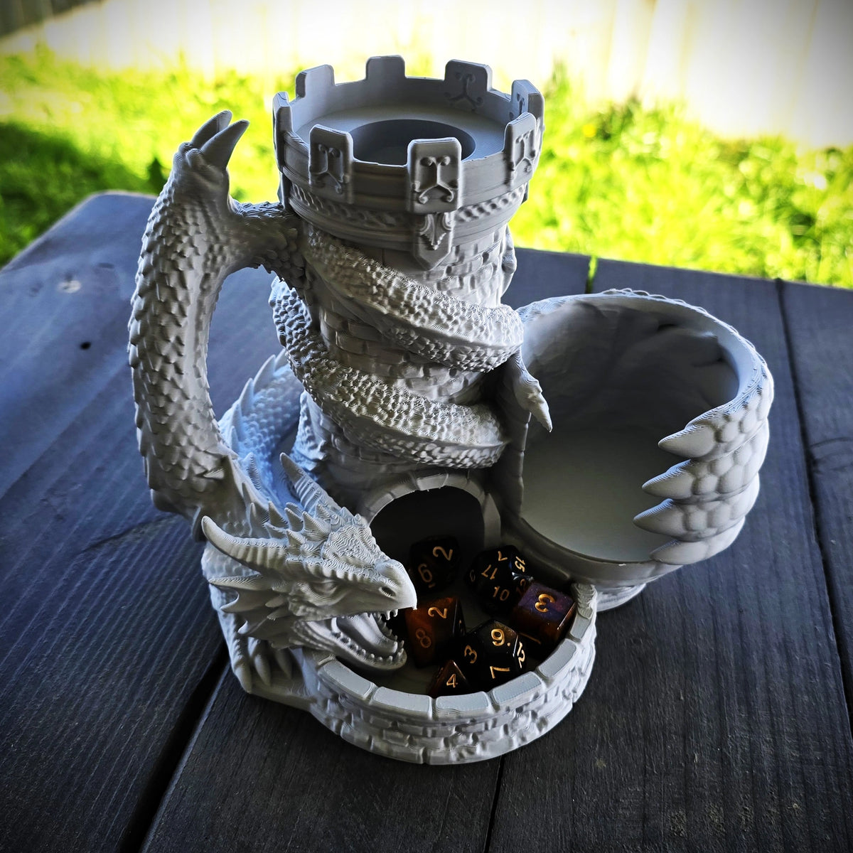 Grey dragon dice tower with integrated can holder, drink can and dice displayed in the front catching tray
