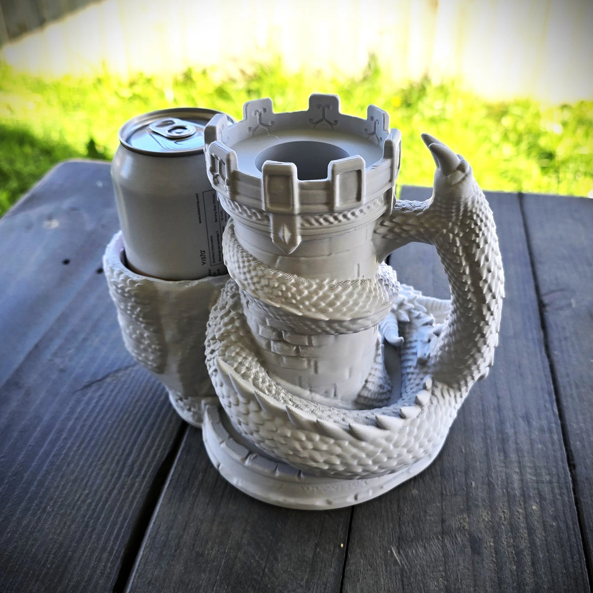 Grey dragon dice tower with integrated can holder, drink can and dice displayed in the front catching tray